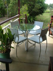 glass & chrome table with 4 white chairs